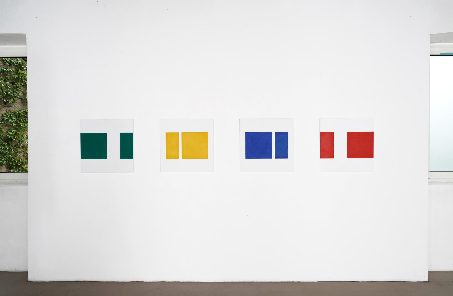 view of installation: gudrun piper, &quot;quadrat im quadrat grün,&quot; &quot;quadrat im quadrat gelb,&quot; &quot;quadrat im quadrat blau,&quot; &quot;quadrat im quadrat rot&quot; all 2002, oil paint and acrylic paint on wood, 60 × 60 cm